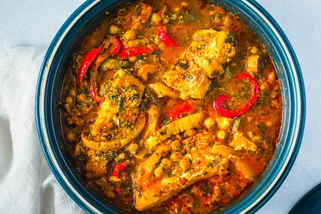 A picture of fish tagine with vegetables looking delicious. 