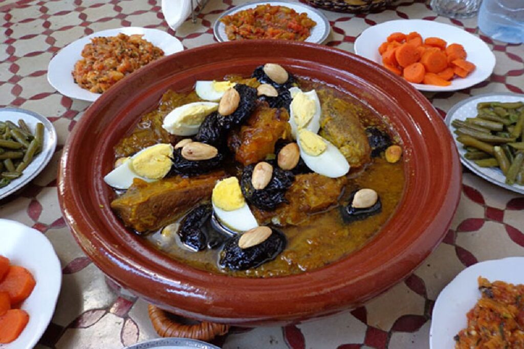 A picture of an original Moroccan lamb and prune tagine with roast almonds and boiled egg. 